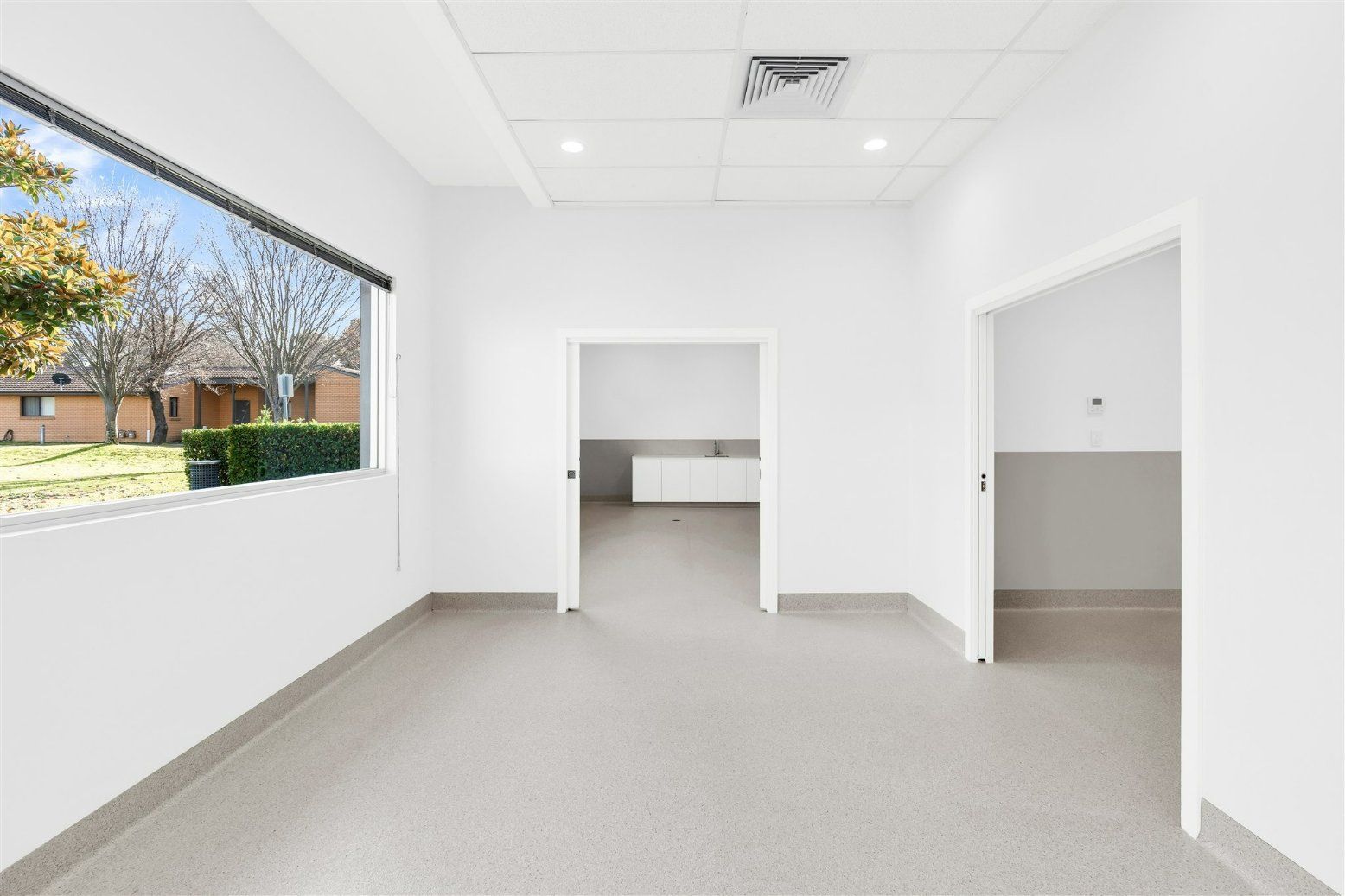 An Empty Room With White Walls and a Window — Moltus Construction in Braddon,  ACT