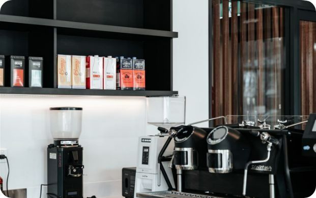 A Kitchen With a Coffee Machine, Grinder, and Shelves — Moltus Construction in Braddon,  ACT