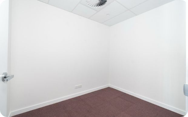An Empty Room With White Walls and a Red Carpet — Moltus Construction in Braddon,  ACT