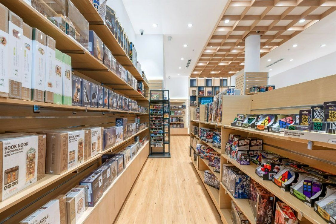 A Store Aisle Filled With Lots of Toys and Books — Moltus Construction in Braddon,  ACT