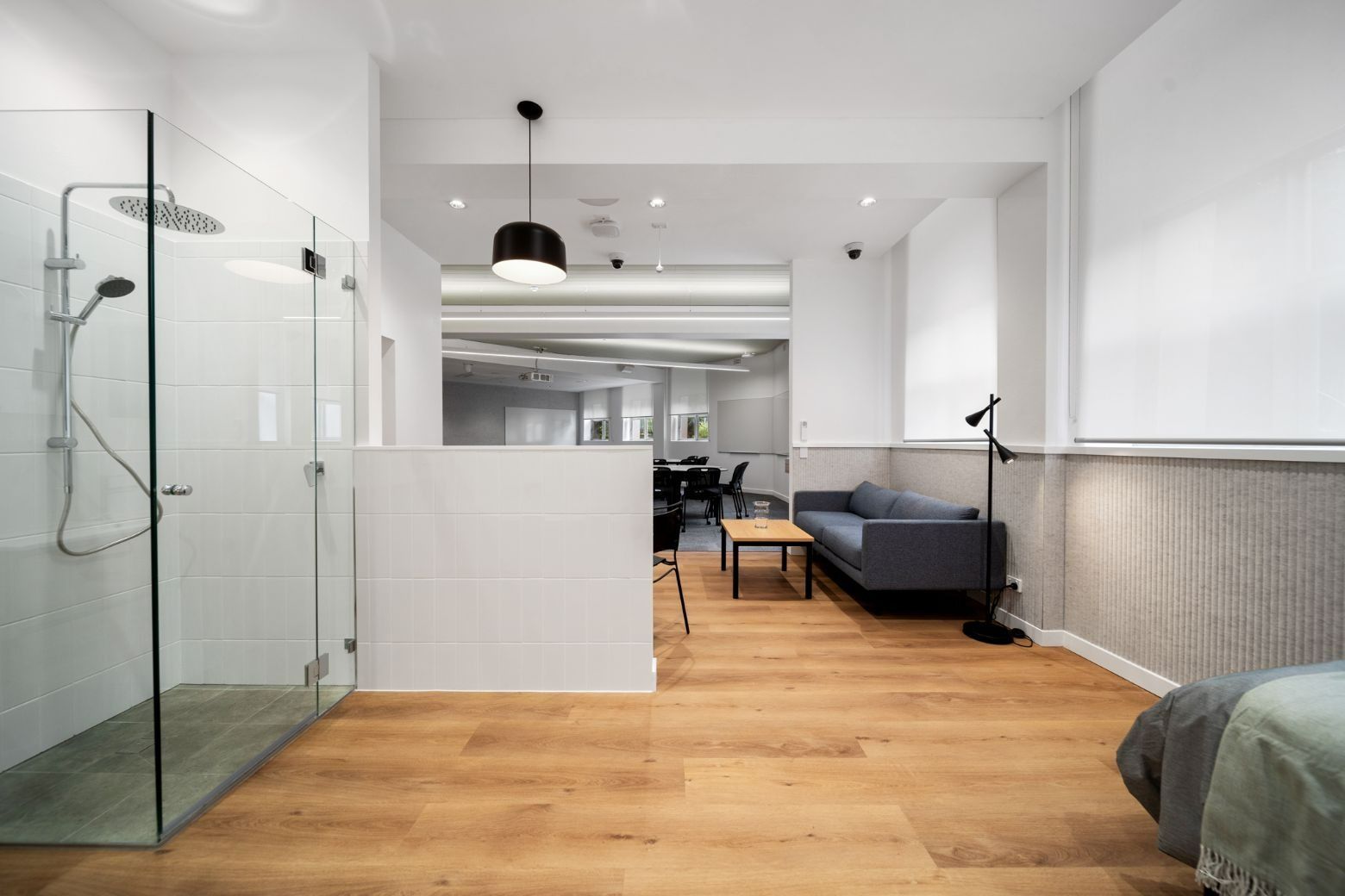 A Living Room With Hardwood Floors, a Couch, and a Walk in Shower — Moltus Construction in Braddon,  ACT