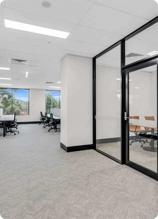 A Large Room With A Lot Of Windows And Tables And Chairs  — Moltus Construction in Braddon, ACT