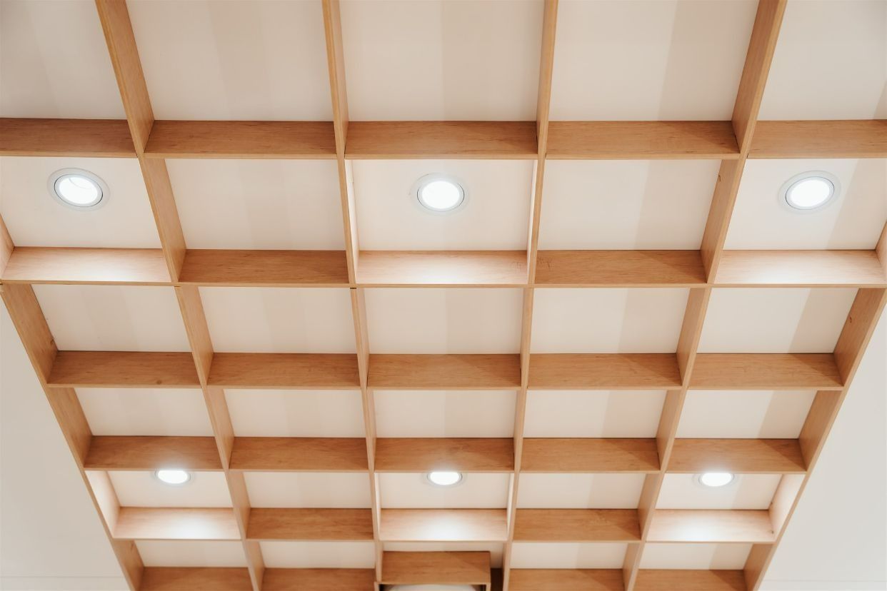 A Ceiling With Wooden Shelves and Lights on It — Moltus Construction in Braddon,  ACT