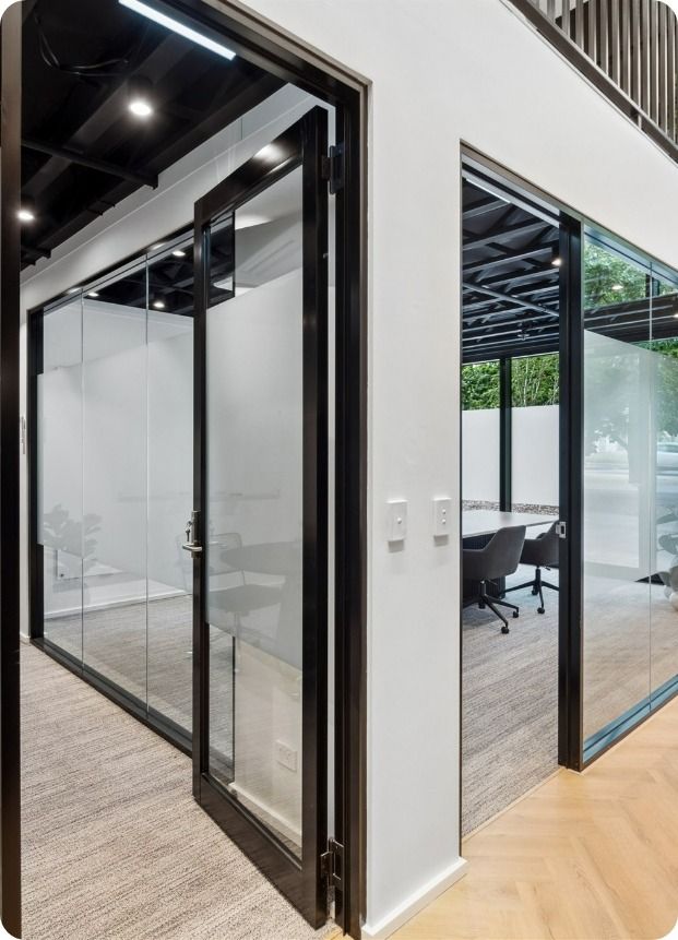 A Room With a Table and Chairs in It and a Glass Door — Moltus Construction in Braddon, ACT