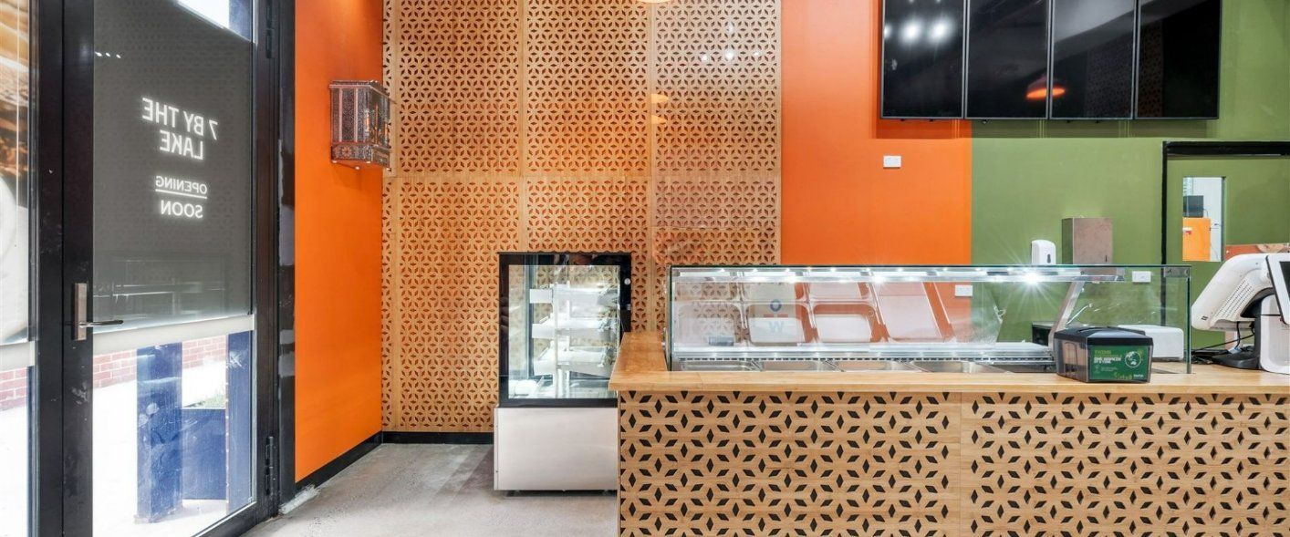 A Bakery With a Counter and a Glass Display Case — Moltus Construction in Braddon,  ACT