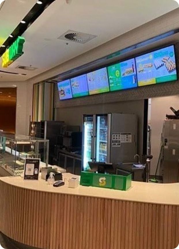 A Subway Restaurant With a Counter and a Refrigerator — Moltus Construction in Braddon,  ACT
