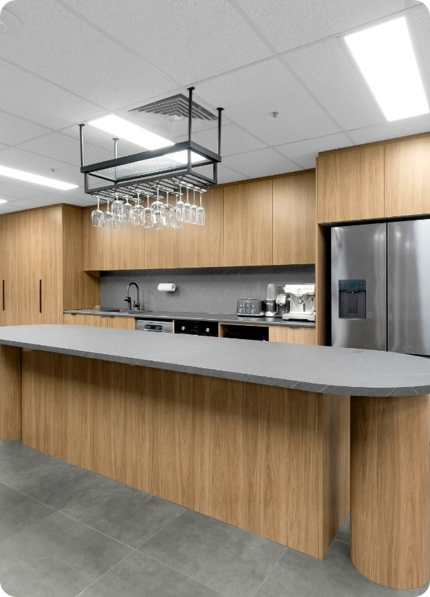 A Kitchen With Wooden Cabinets and a Gray Counter Top — Moltus Construction in Braddon,  ACT
