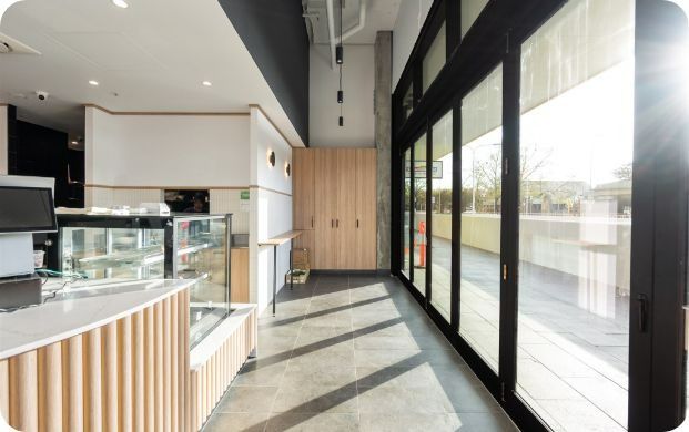 A Large Room With a Lot of Windows and a Counter — Moltus Construction in Braddon,  ACT