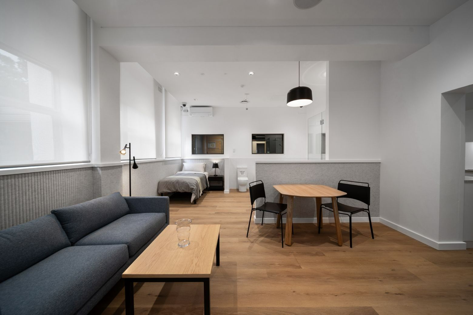 A room with a table, chairs, couch and single bed  — Moltus Construction in Sunshine Coast, QLD