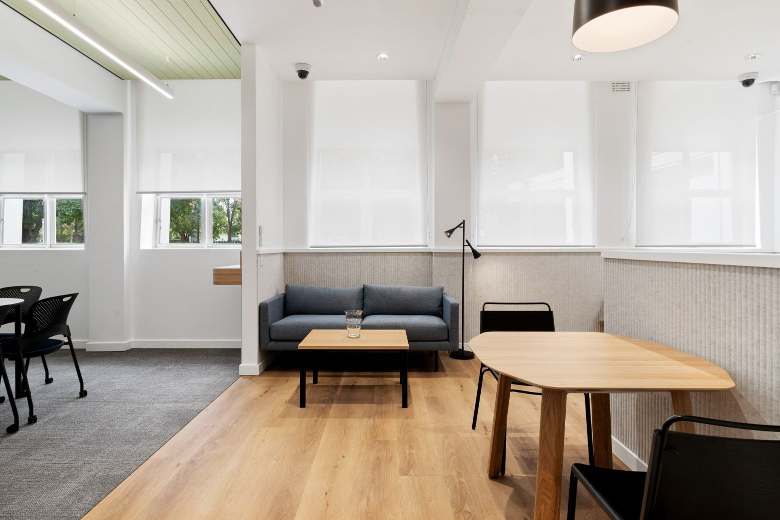 A Living Room With a Couch, Table and Chairs — Moltus Construction in Braddon,  ACT