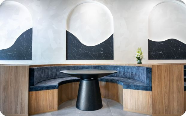 A Room With a Round Table and a Curved Bench — Moltus Construction in Braddon,  ACT