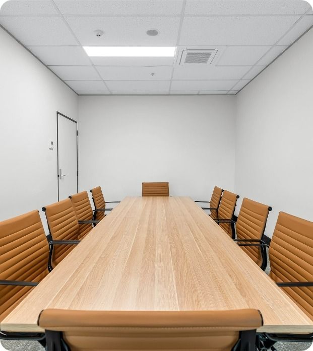 A Conference Room With A Long Wooden Table And Chairs  — Moltus Construction in Braddon, ACT