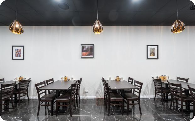 A Restaurant With Tables and Chairs and Pictures on the Wall — Moltus Construction in Braddon,  ACT