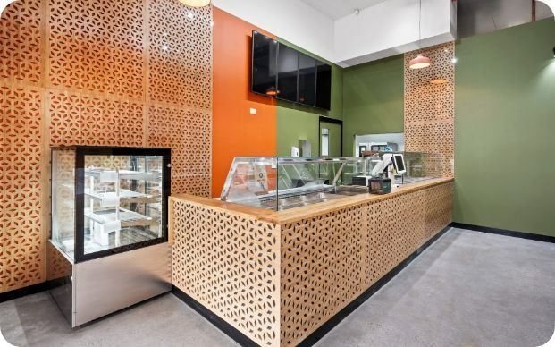 A Restaurant With a Counter and a Display Case — Moltus Construction in Braddon,  ACT