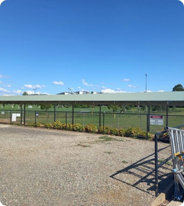 A Parking Lot With a Fence and a Sign That Says Danger — Moltus Construction in Braddon,  ACT