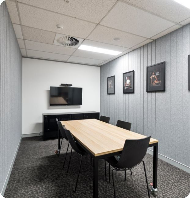 A Conference Room With a Table and Chairs and a Flat Screen Tv — Moltus Construction in Braddon,  ACT