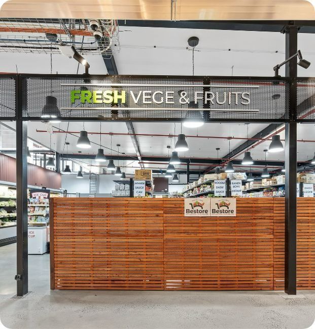 A Fresh Vege and Fruits Store With a Wooden Counter — Moltus Construction in Braddon,  ACT