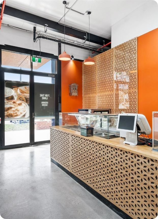 A Restaurant With a Wooden Counter and a Computer on It — Moltus Construction in Braddon,  ACT