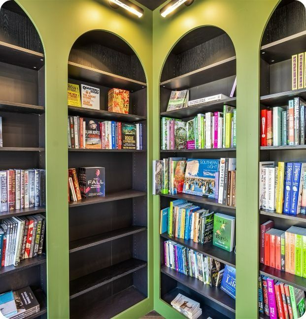 A Corner of a Library Filled With Lots of Books — Moltus Construction in Braddon,  ACT