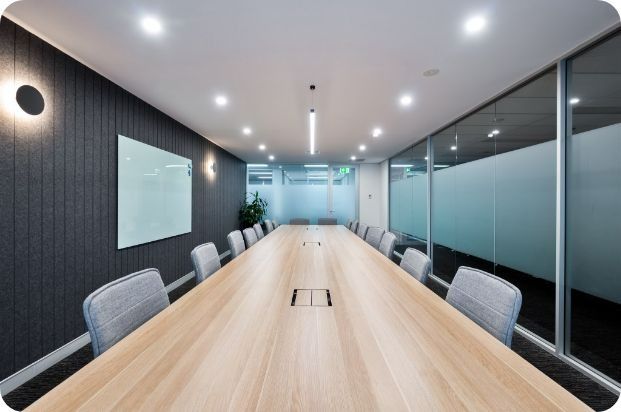 A Conference Room With a Long Wooden Table and Chairs — Moltus Construction in Braddon,  ACT