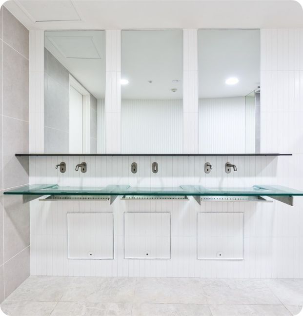 A Bathroom With Three Sinks and Three Mirrors — Moltus Construction in Braddon,  ACT