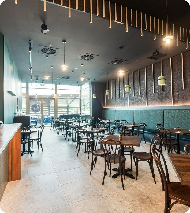 A Restaurant With a Lot of Tables and Chairs — Moltus Construction in Braddon,  ACT