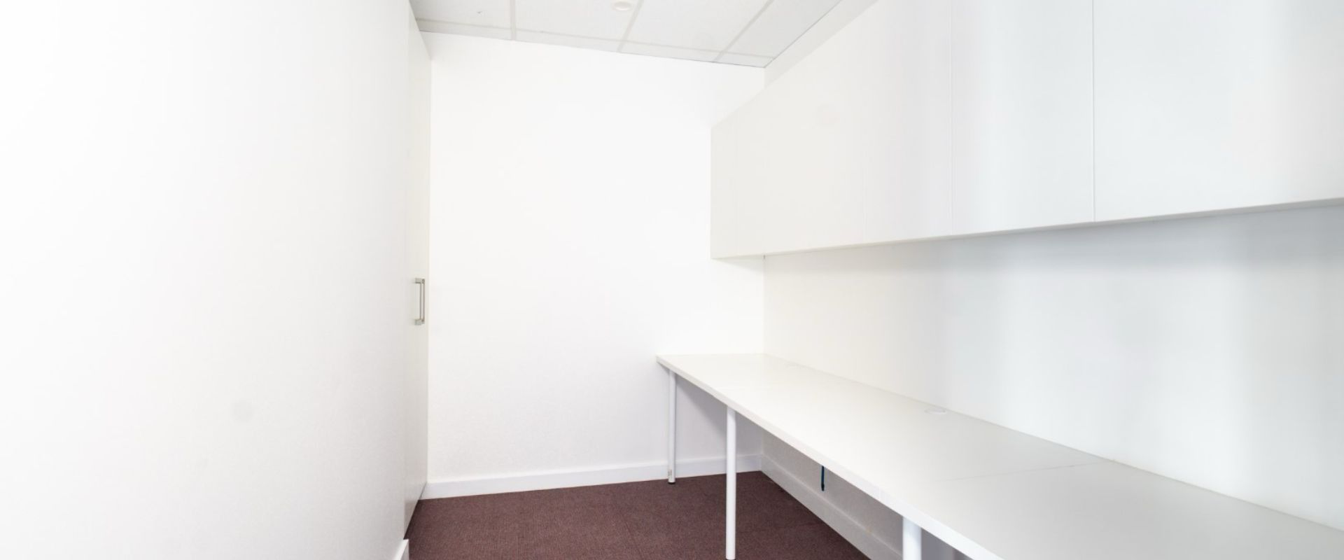 An Empty Room With a Desk and Shelves in It — Moltus Construction in Braddon,  ACT