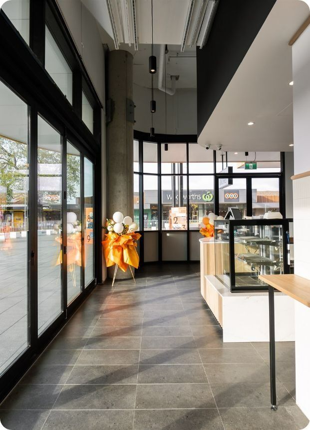 An empty sushi restaurant with lots on windows — Moltus Construction in Brisbane, QLD