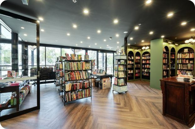 A Book Store With Lots of Books on Shelves — Moltus Construction in Braddon,  ACT