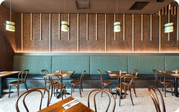 A Restaurant With Tables and Chairs and a Bench — Moltus Construction in Braddon,  ACT