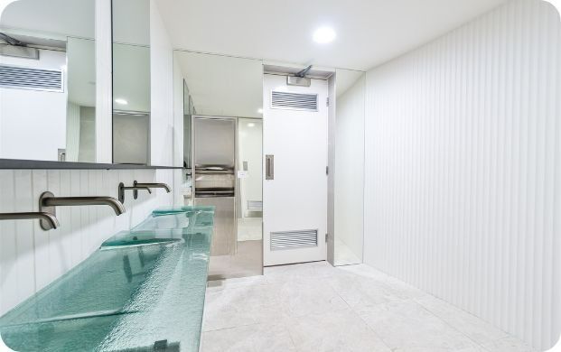 A Bathroom With Two Sinks and a Door — Moltus Construction in Braddon,  ACT