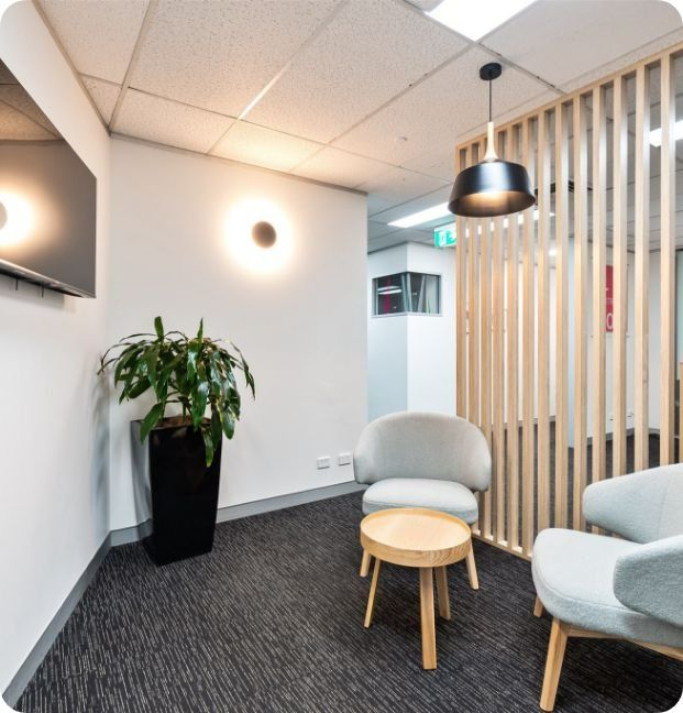 A Room With Chairs a Table and a Potted Plant — Moltus Construction in Braddon,  ACT