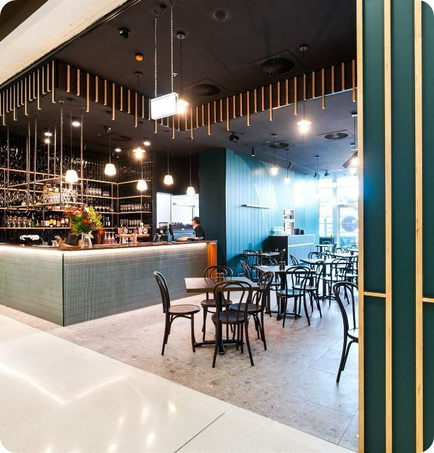 A Restaurant With Tables and Chairs and a Bar — Moltus Construction in Braddon,  ACT