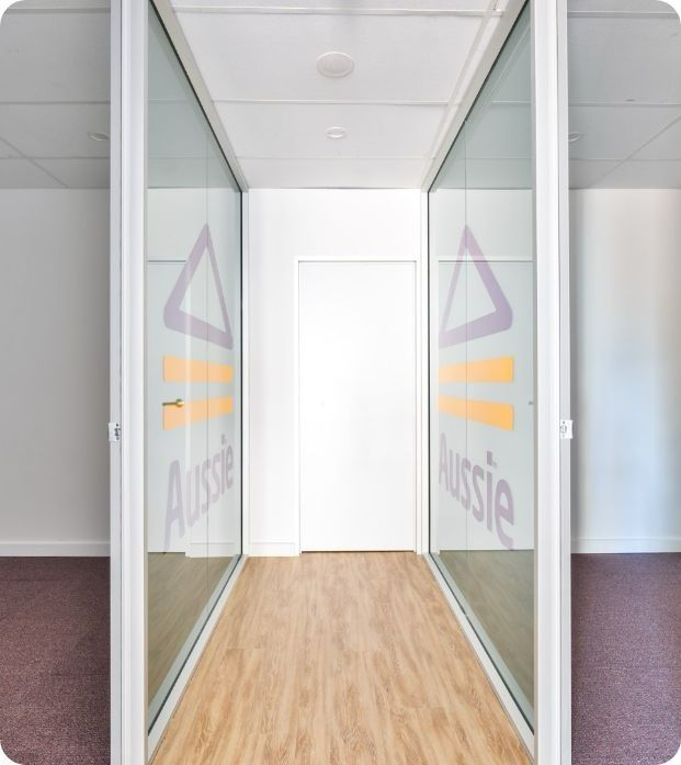 A Hallway With a Sign on the Wall That Says Aussie — Moltus Construction in Braddon,  ACT