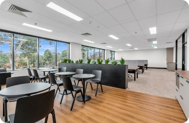 A Large Room With Tables and Chairs in It — Moltus Construction in Braddon,  ACT