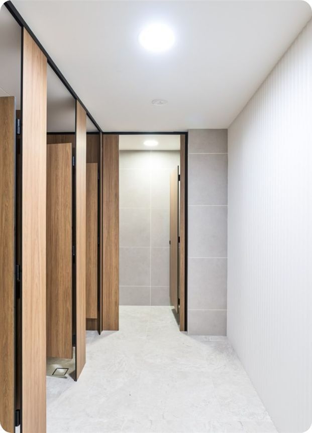 A Hallway With Wooden Dividers and a Door Leading to a Bathroom — Moltus Construction in Braddon,  ACT