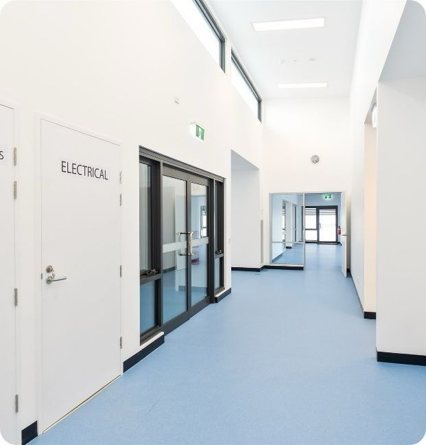 A Hallway With Electrical Written on the Door — Moltus Construction in Braddon,  ACT