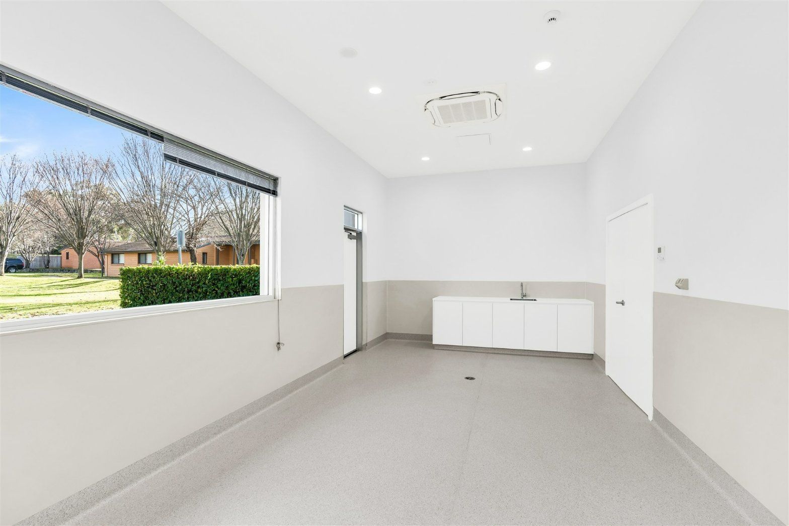 An Empty Room With a Window and a Sink in It — Moltus Construction in Braddon,  ACT
