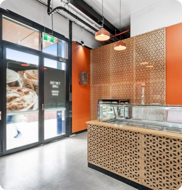 A Restaurant With Orange Walls and a Counter — Moltus Construction in Braddon,  ACT