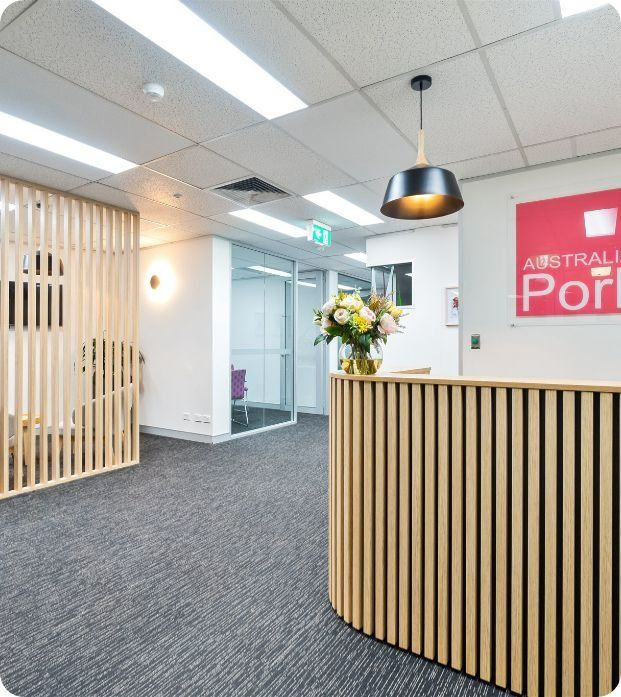 A Reception Area With a Sign That Says Australia Port — Moltus Construction in Braddon,  ACT