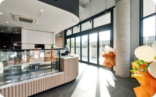 A Large Room With a Lot of Windows and a Display Case — Moltus Construction in Braddon,  ACT