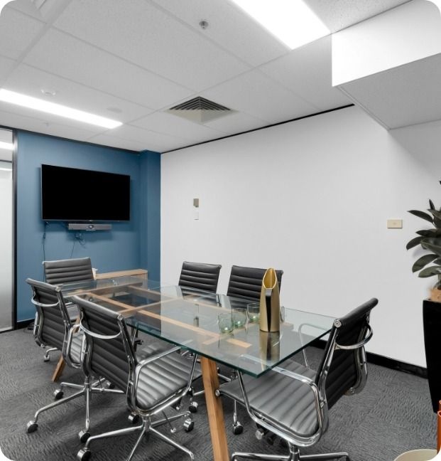A Conference Room With a Glass Table and Chairs — Moltus Construction in Braddon,  ACT