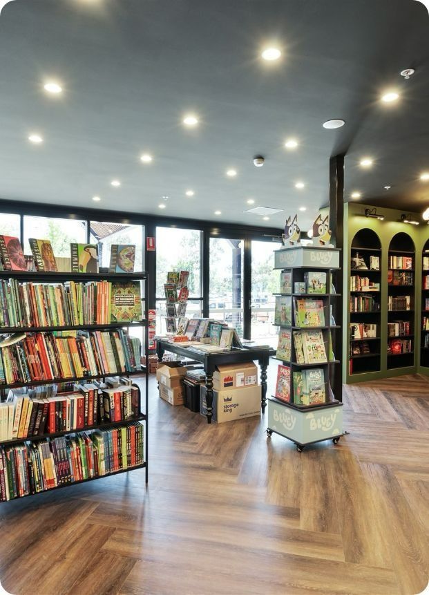 A Bookstore With Lots of Books on Shelves and a Wooden Floor — Moltus Construction in Braddon,  ACT