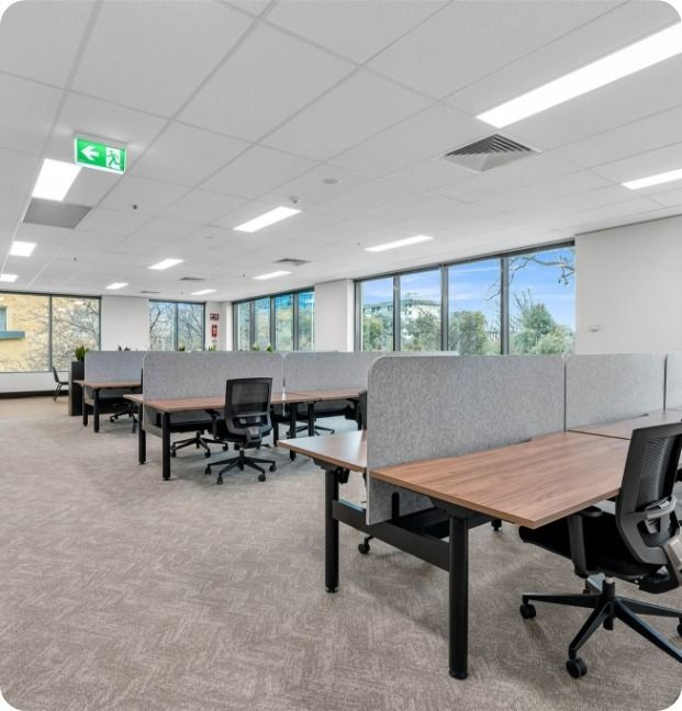 A Large Office With Lots of Desks and Chairs — Moltus Construction in Braddon,  ACT