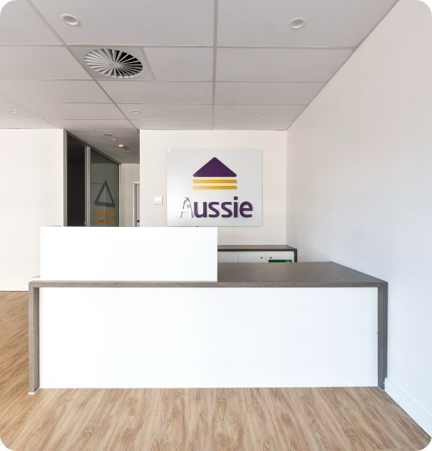 A White Desk With a Sign Above It That Says Aussie — Moltus Construction in Braddon,  ACT