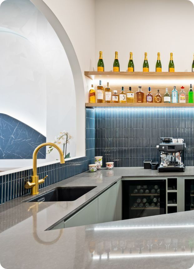 A Kitchen With a Sink and a Shelf With Bottles on It — Moltus Construction in Braddon,  ACT