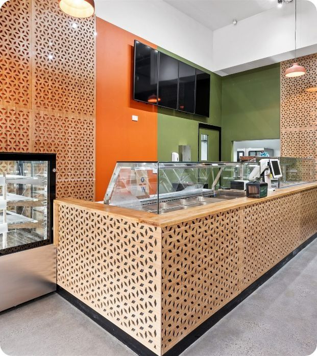 A Bakery With a Wooden Counter and a Glass Display Case — Moltus Construction in Braddon,  ACT