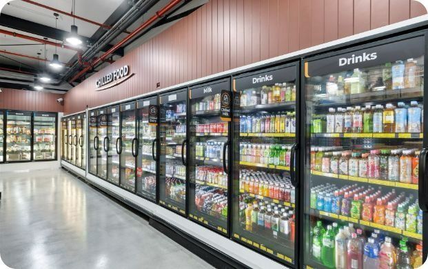 A Row of Refrigerators Filled With Drinks in a Grocery Store — Moltus Construction in Braddon,  ACT