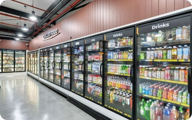A Row of Refrigerators Filled With Drinks in a Grocery Store — Moltus Construction in Braddon,  ACT