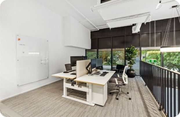 A Room With Two Desks and Two Chairs in It — Moltus Construction in Braddon,  ACT